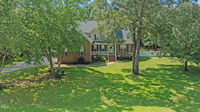 102 Sevendales Dr, Goldsboro, NC 27534 - view of property hidden behind natural elements featuring brick siding, a front yard, and a porch