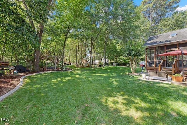 102 Sevendales Dr, Goldsboro, NC 27534 - view of grassy yard with a sunroom and a playground