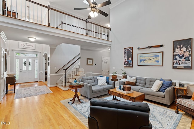 102 Sevendales Dr, Goldsboro, NC 27534 - living area featuring stairway, a high ceiling, ceiling fan, wood finished floors, and crown molding