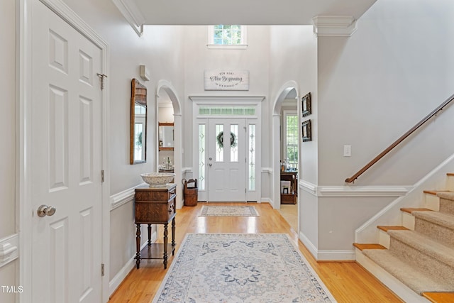 102 Sevendales Dr, Goldsboro, NC 27534 - foyer entrance with arched walkways, light wood finished floors, stairway, and baseboards