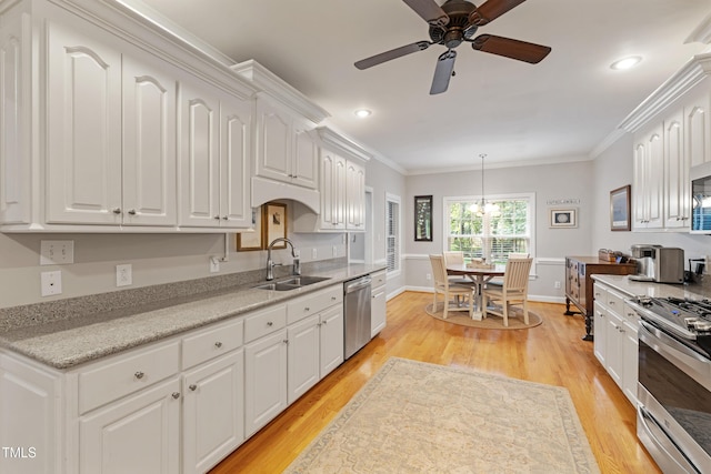 102 Sevendales Dr, Goldsboro, NC 27534 - kitchen with a sink, appliances with stainless steel finishes, white cabinetry, a ceiling fan, and light wood-style flooring