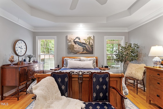 102 Sevendales Dr, Goldsboro, NC 27534 - bedroom featuring a tray ceiling, light wood-type flooring, multiple windows, and crown molding
