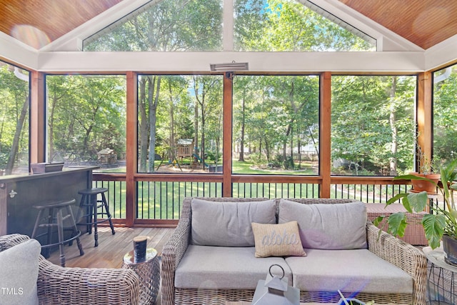 102 Sevendales Dr, Goldsboro, NC 27534 - sunroom featuring vaulted ceiling, outdoor lounge area, view of wooded area, and plenty of natural light