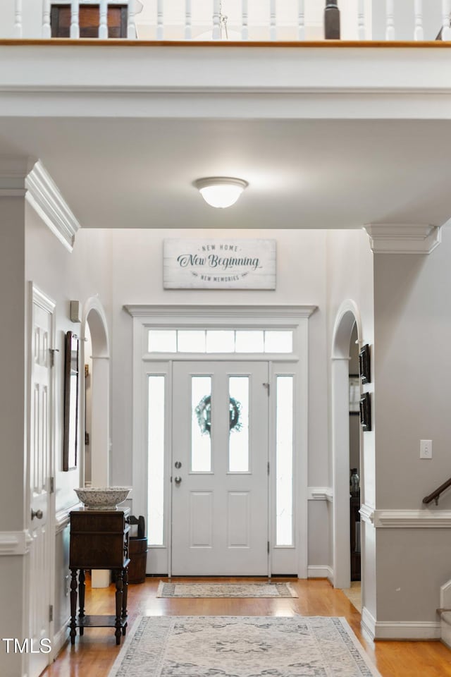 102 Sevendales Dr, Goldsboro, NC 27534 - entrance foyer with arched walkways, light wood finished floors, and stairway