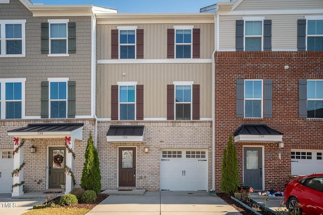 732 Suffield Way, Cary, NC 27519 - townhome / multi-family property with an attached garage, concrete driveway, brick siding, and a standing seam roof