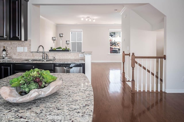 732 Suffield Way, Cary, NC 27519 - kitchen with stainless steel dishwasher, light stone counters, dark cabinetry, and wood finished floors