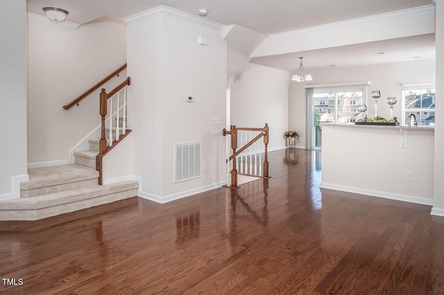 732 Suffield Way, Cary, NC 27519 - staircase with ornamental molding, wood finished floors, and a chandelier