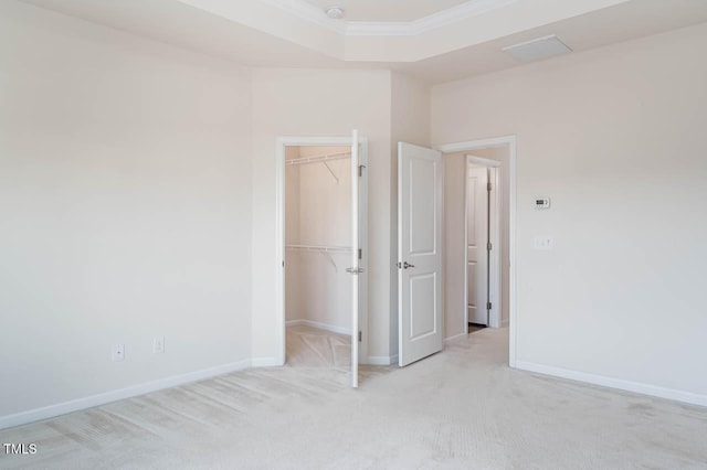 732 Suffield Way, Cary, NC 27519 - unfurnished bedroom featuring light carpet, ornamental molding, a walk in closet, and a closet