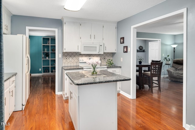 202 Howland Ave, Cary, NC 27513 - kitchen featuring white appliances, light wood finished floors, backsplash, white cabinetry, and a kitchen island