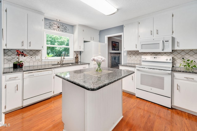 202 Howland Ave, Cary, NC 27513 - kitchen with white appliances, tasteful backsplash, white cabinets, light wood-style flooring, and a textured ceiling
