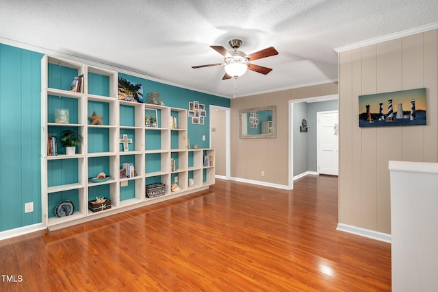 202 Howland Ave, Cary, NC 27513 - empty room featuring a ceiling fan, wood finished floors, ornamental molding, and a textured ceiling