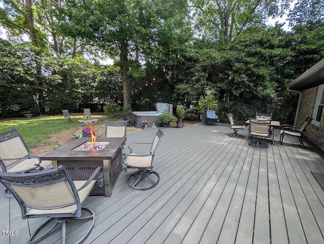 202 Howland Ave, Cary, NC 27513 - deck featuring an outdoor fire pit, outdoor dining space, and view of wooded area