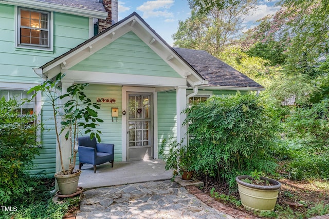 108 High St, Carrboro, NC 27510 - entrance to property featuring a shingled roof, a chimney, and a porch
