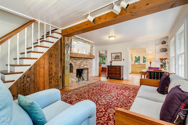 108 High St, Carrboro, NC 27510 - living area with wood finished floors, stairs, and a brick fireplace