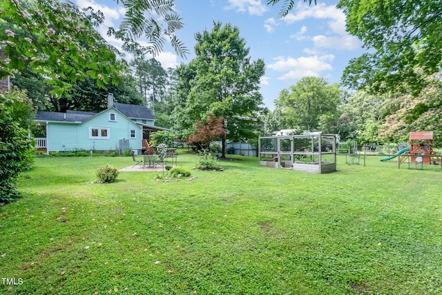 108 High St, Carrboro, NC 27510 - view of yard with a vegetable garden, a patio, a playground, and view of scattered trees