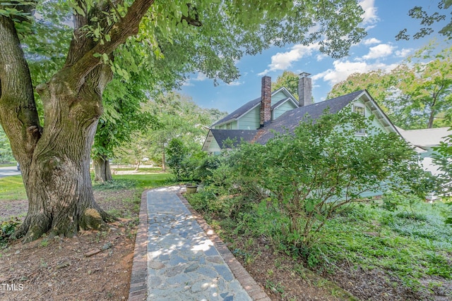 108 High St, Carrboro, NC 27510 - view of side of property with a chimney and roof with shingles