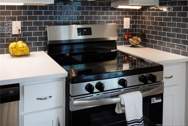 108 Pine St, Dunn, NC 28334 - kitchen featuring stainless steel electric stove, backsplash, light countertops, and white cabinets