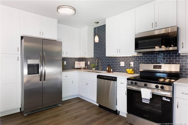 108 Pine St, Dunn, NC 28334 - kitchen featuring appliances with stainless steel finishes, light countertops, a sink, and white cabinets