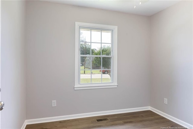 108 Pine St, Dunn, NC 28334 - unfurnished room with healthy amount of natural light, baseboards, and dark wood-type flooring