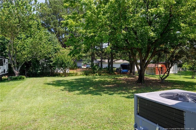 108 Pine St, Dunn, NC 28334 - view of green lawn featuring central air condition unit