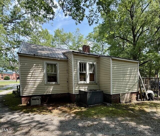 981 Leasburg Rd, Roxboro, NC 27573 - back of property featuring a chimney, a metal roof, and crawl space