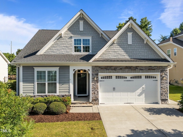 427 Cedar Pond Ct, Knightdale, NC 27545 - craftsman house featuring an attached garage, driveway, stone siding, and a shingled roof