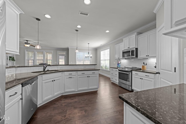 427 Cedar Pond Ct, Knightdale, NC 27545 - kitchen featuring stainless steel appliances, ornamental molding, backsplash, white cabinetry, and recessed lighting