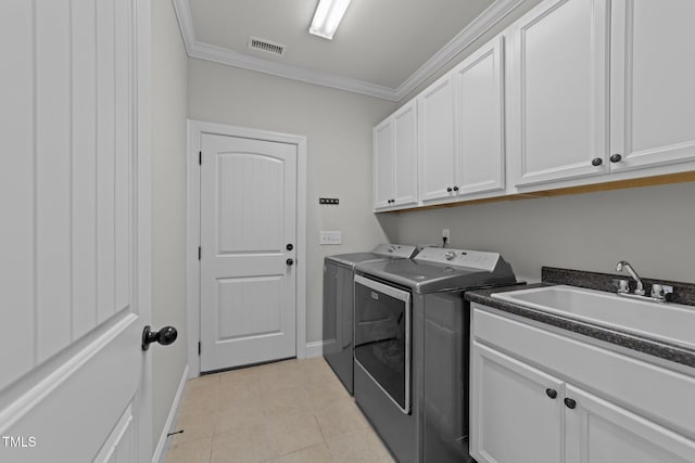 427 Cedar Pond Ct, Knightdale, NC 27545 - laundry room featuring washer and dryer, cabinet space, crown molding, and light tile patterned floors