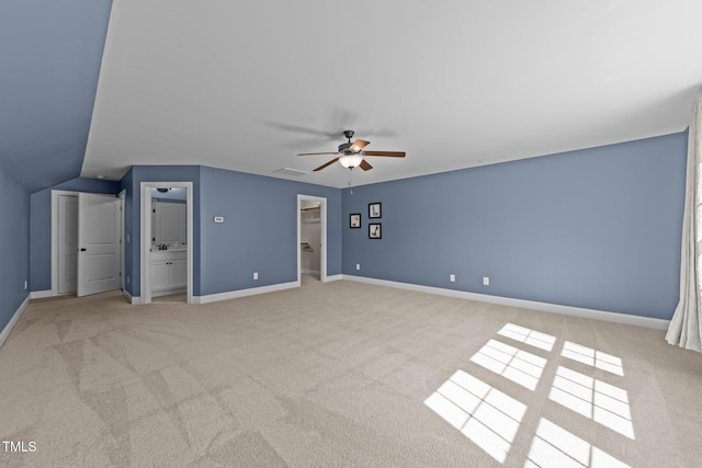 427 Cedar Pond Ct, Knightdale, NC 27545 - unfurnished bedroom featuring carpet floors, a walk in closet, connected bathroom, a ceiling fan, and lofted ceiling