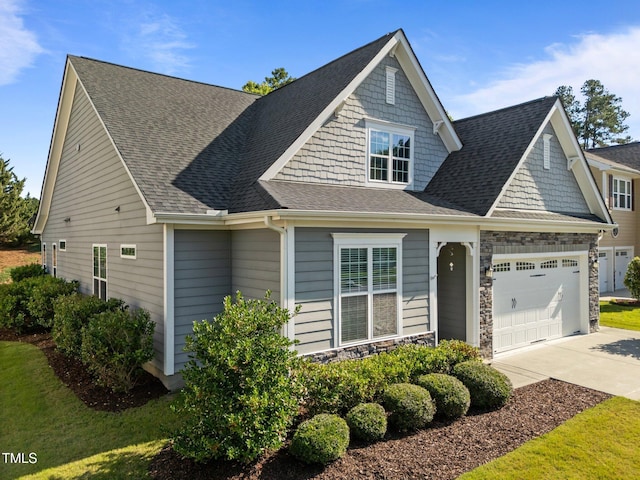 427 Cedar Pond Ct, Knightdale, NC 27545 - craftsman-style home with driveway, a garage, roof with shingles, and stone siding