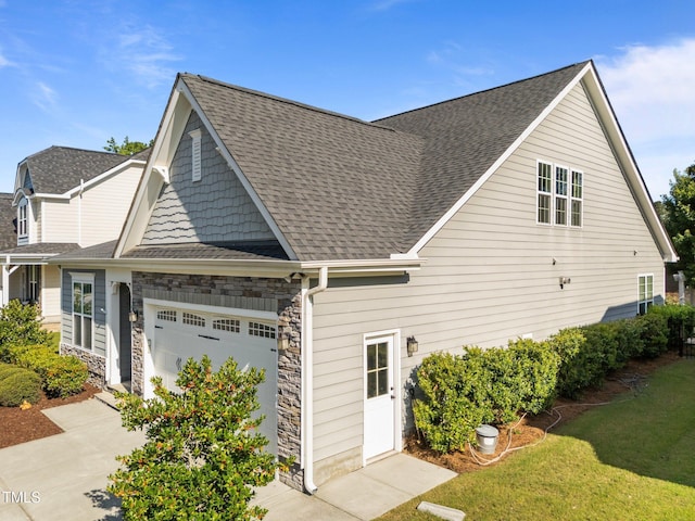 427 Cedar Pond Ct, Knightdale, NC 27545 - view of front of home with a garage, stone siding, roof with shingles, a front lawn, and driveway