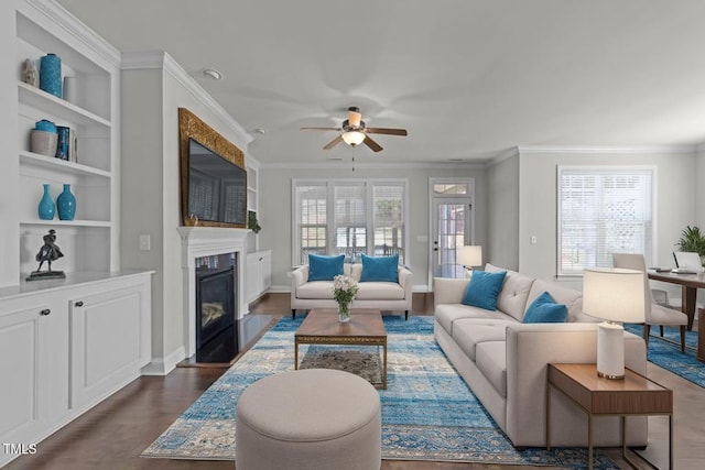 427 Cedar Pond Ct, Knightdale, NC 27545 - living room with a fireplace with flush hearth, crown molding, ceiling fan, and dark wood-type flooring