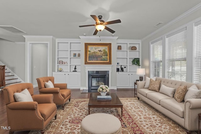 427 Cedar Pond Ct, Knightdale, NC 27545 - living area with wood finished floors, stairs, ceiling fan, a fireplace with flush hearth, and crown molding