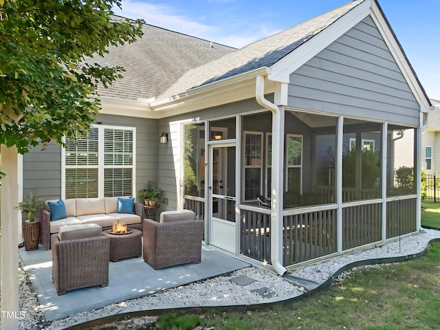427 Cedar Pond Ct, Knightdale, NC 27545 - back of property featuring a shingled roof, a sunroom, a patio, and an outdoor living space with a fire pit