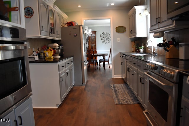 408 Greenfern Ct, Burlington, NC 27215 - kitchen with appliances with stainless steel finishes, dark countertops, backsplash, dark wood finished floors, and recessed lighting