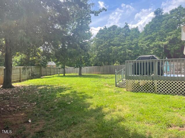 408 Greenfern Ct, Burlington, NC 27215 - fenced backyard featuring a wooden deck