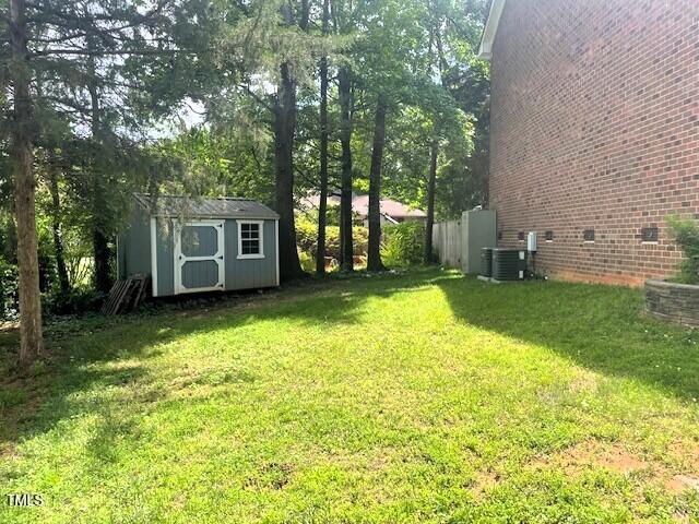 408 Greenfern Ct, Burlington, NC 27215 - view of green lawn with a storage shed