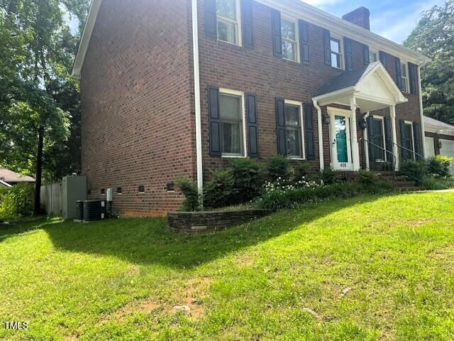 408 Greenfern Ct, Burlington, NC 27215 - view of side of home featuring brick siding, a yard, and a chimney