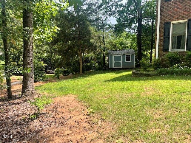 408 Greenfern Ct, Burlington, NC 27215 - view of green lawn with a shed