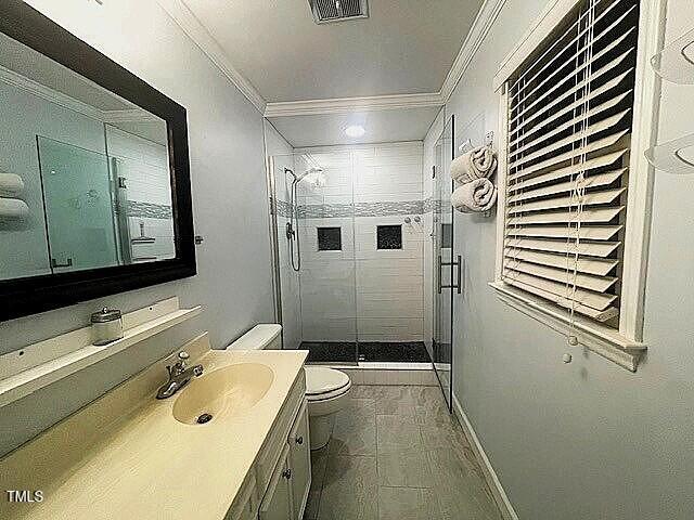 408 Greenfern Ct, Burlington, NC 27215 - bathroom featuring ornamental molding, a stall shower, and vanity