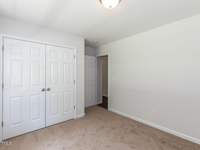 381 Gray Ghost Ln, Benson, NC 27504 - unfurnished bedroom with carpet floors and a closet