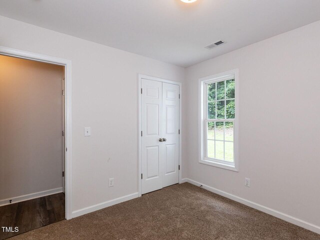 381 Gray Ghost Ln, Benson, NC 27504 - unfurnished bedroom with carpet and a closet