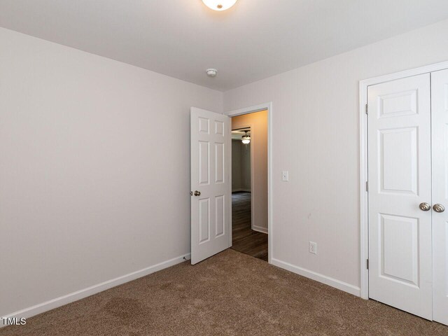 381 Gray Ghost Ln, Benson, NC 27504 - unfurnished bedroom with carpet floors and baseboards