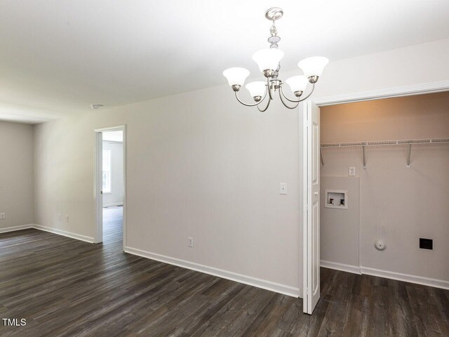 381 Gray Ghost Ln, Benson, NC 27504 - unfurnished dining area featuring a chandelier and dark wood-style flooring