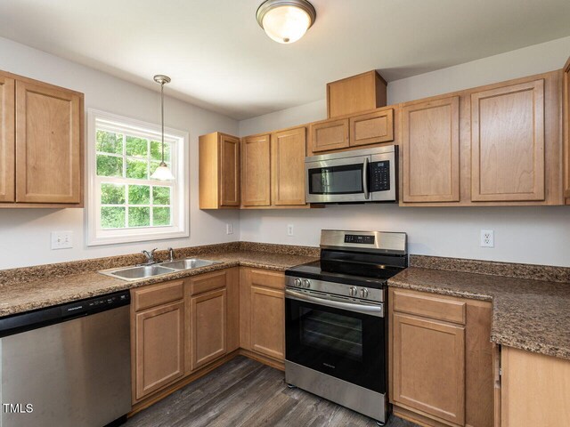381 Gray Ghost Ln, Benson, NC 27504 - kitchen featuring stainless steel appliances, dark wood finished floors, hanging light fixtures, and dark countertops