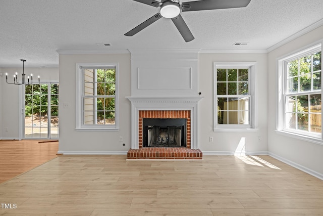 103 Burham Ct, Apex, NC 27502 - unfurnished living room with healthy amount of natural light, a chandelier, ornamental molding, light wood-style flooring, and a textured ceiling