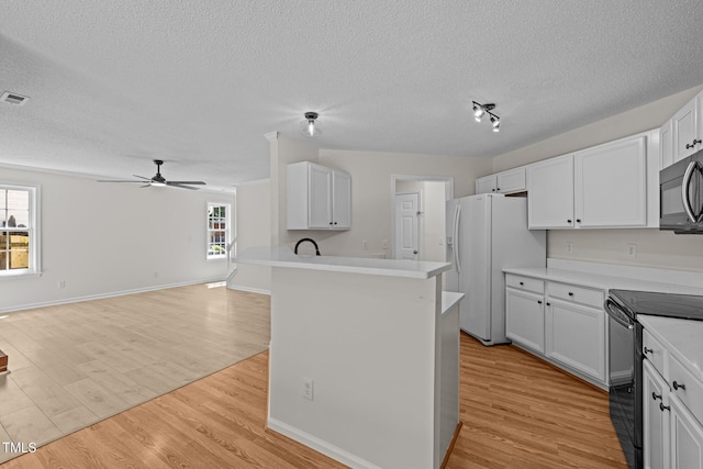 103 Burham Ct, Apex, NC 27502 - kitchen with black appliances, a textured ceiling, ceiling fan, open floor plan, and white cabinets