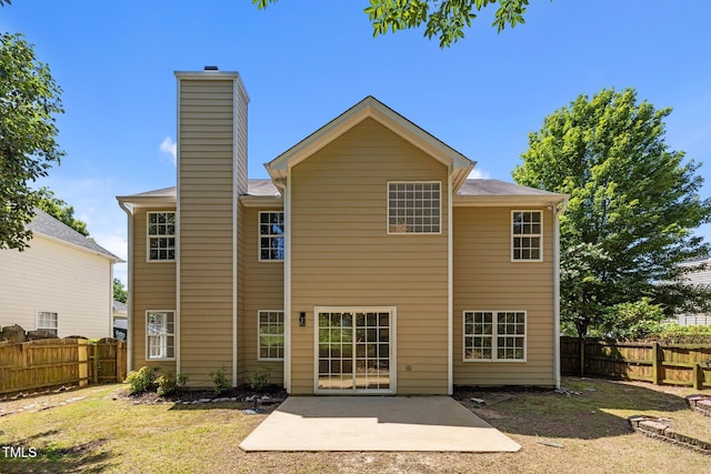 103 Burham Ct, Apex, NC 27502 - rear view of house with a chimney, a patio, and a fenced backyard