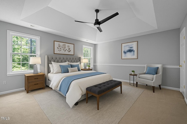 103 Burham Ct, Apex, NC 27502 - carpeted bedroom with a raised ceiling, multiple windows, and a ceiling fan
