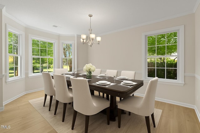 103 Burham Ct, Apex, NC 27502 - dining area featuring a chandelier, light wood finished floors, and ornamental molding